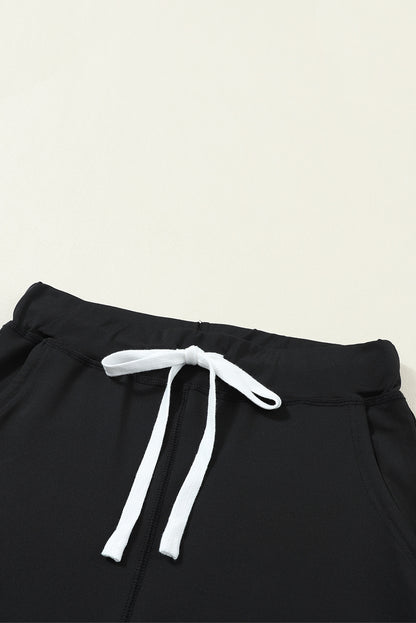 Pantalones jogger negros con cordón, cintura elástica y bolsillos