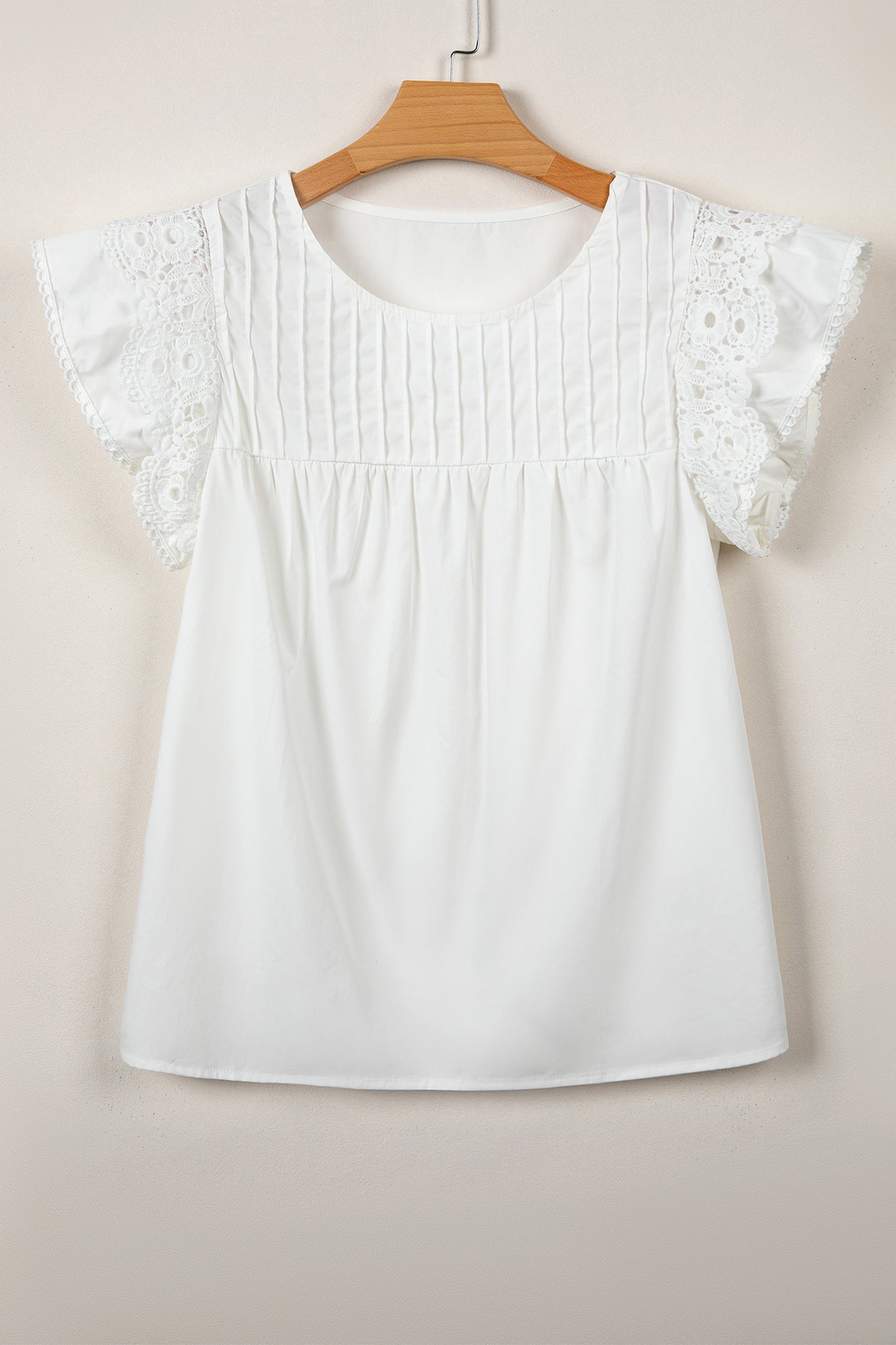 Blusa con detalle de encaje blanco, manga con volantes y cuello redondo plisado