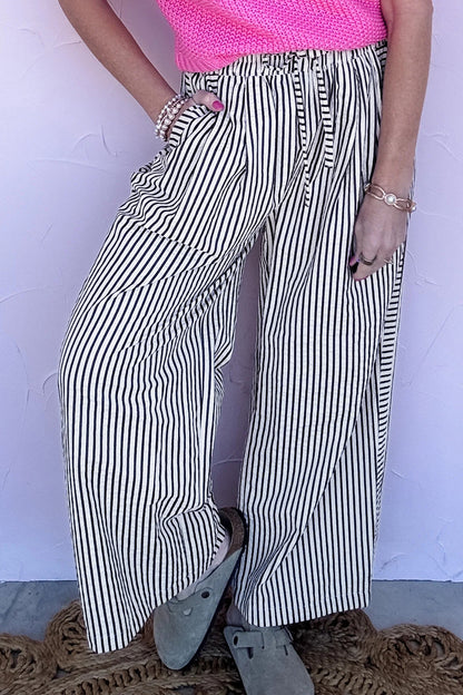 Pantalones casuales negros de pernera ancha con raya