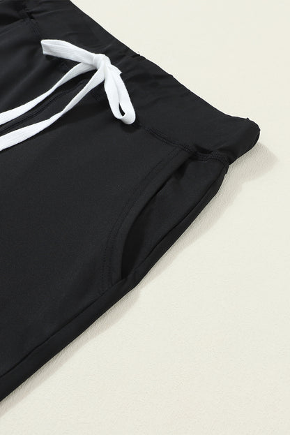 Pantalones jogger negros con cordón, cintura elástica y bolsillos