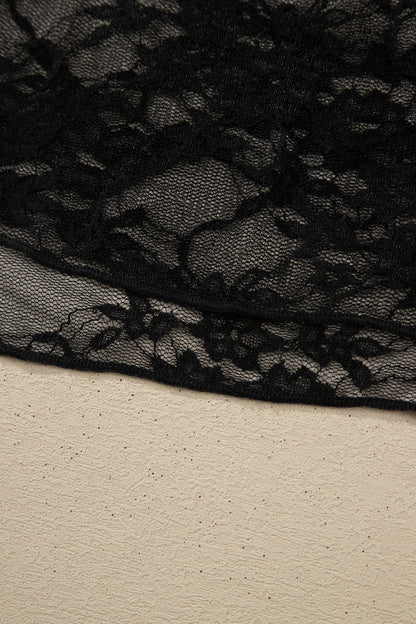 Top de manga larga de encaje floral semitransparente negro con cuello simulado y dobladillo ondulado