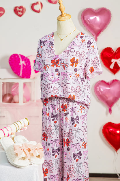 Pijama de pantalón corto con botones, lazos diversos, estampado y ribete en contraste en color rosa
