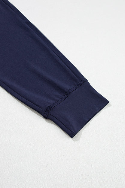 Pantalones deportivos azul marino con cordón ajustable en la cintura elástica y bolsillos