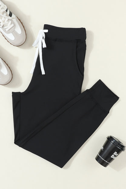 Pantalones jogger negros con cordón, cintura elástica y bolsillos